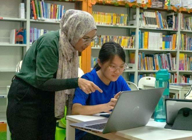 A dedicated teacher providing guidance through a personalized mentor programme at an international school in the Puchong area.